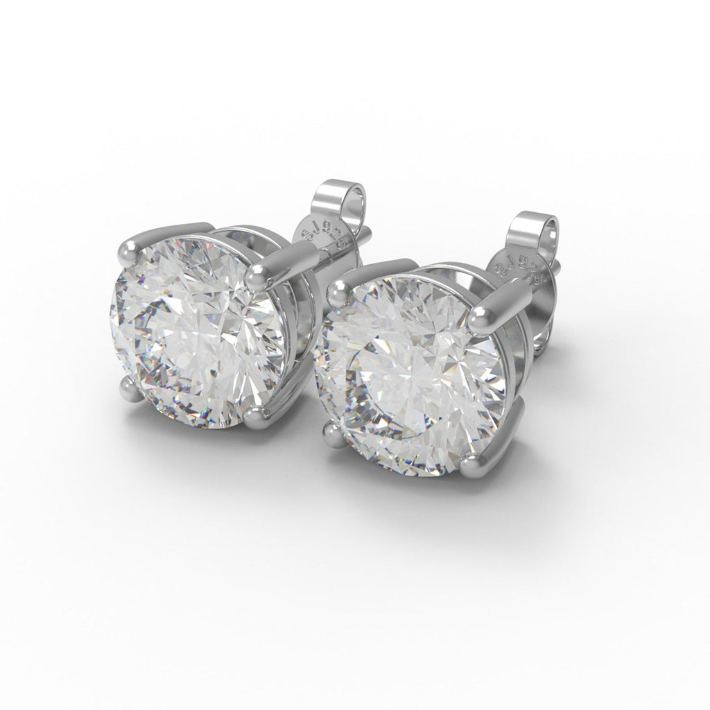 Pair of sterling silver moissanite stud earrings on a white background