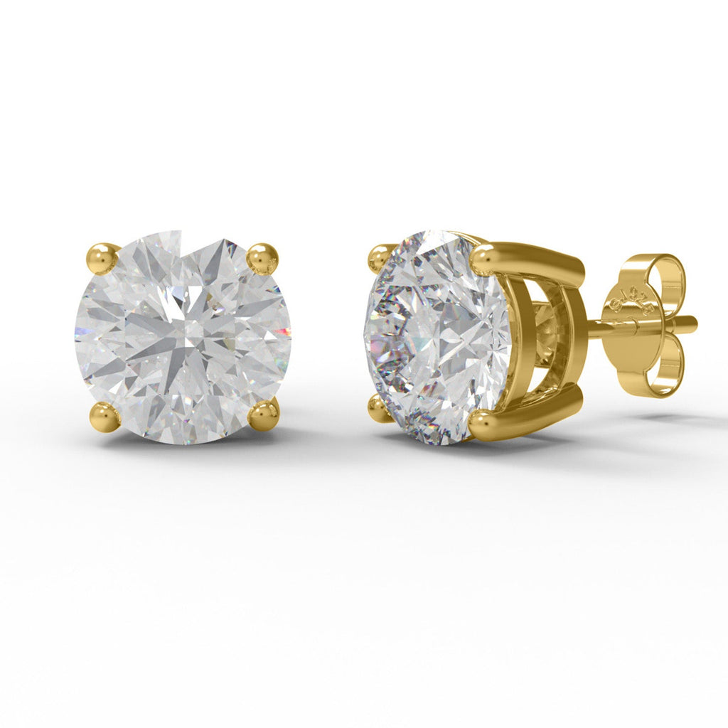 Pair of gold moissanite stud earrings on a white background