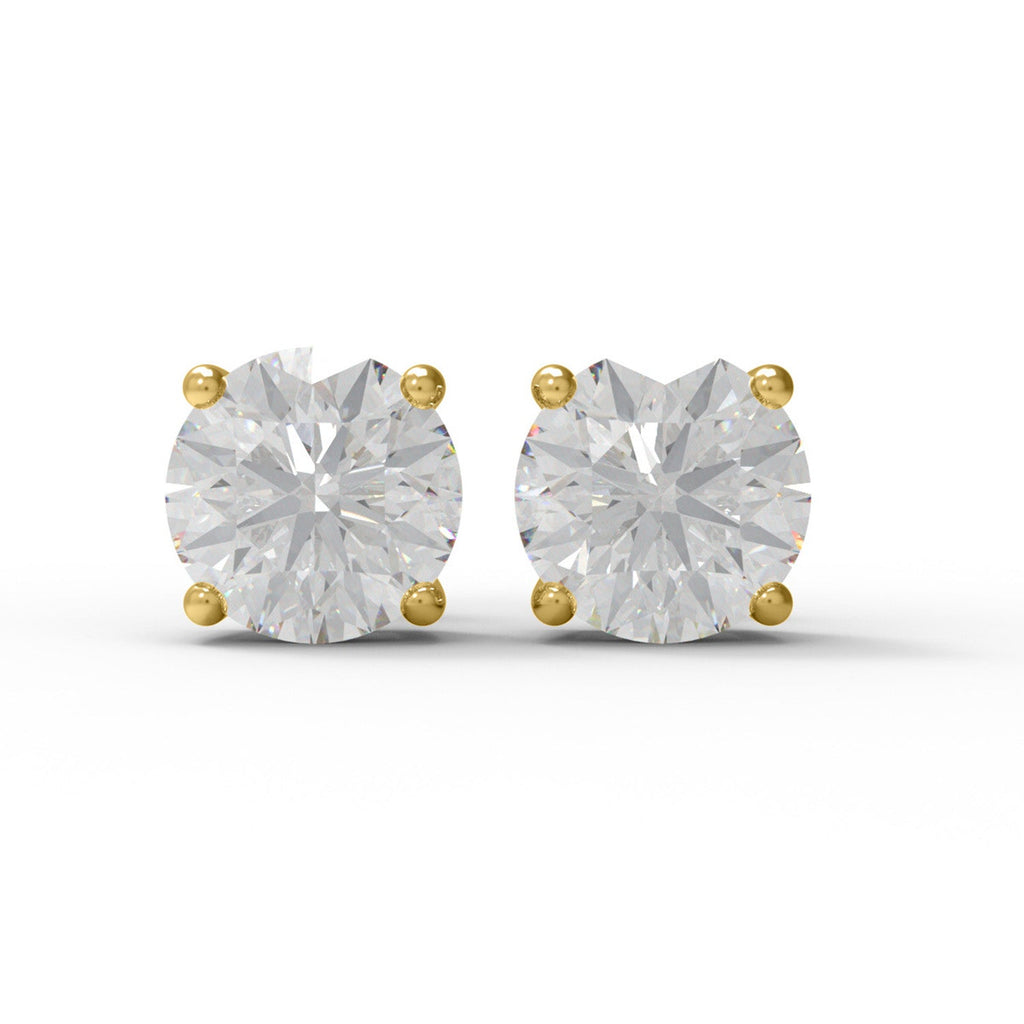 Pair of gold moissanite stud earrings on a white background