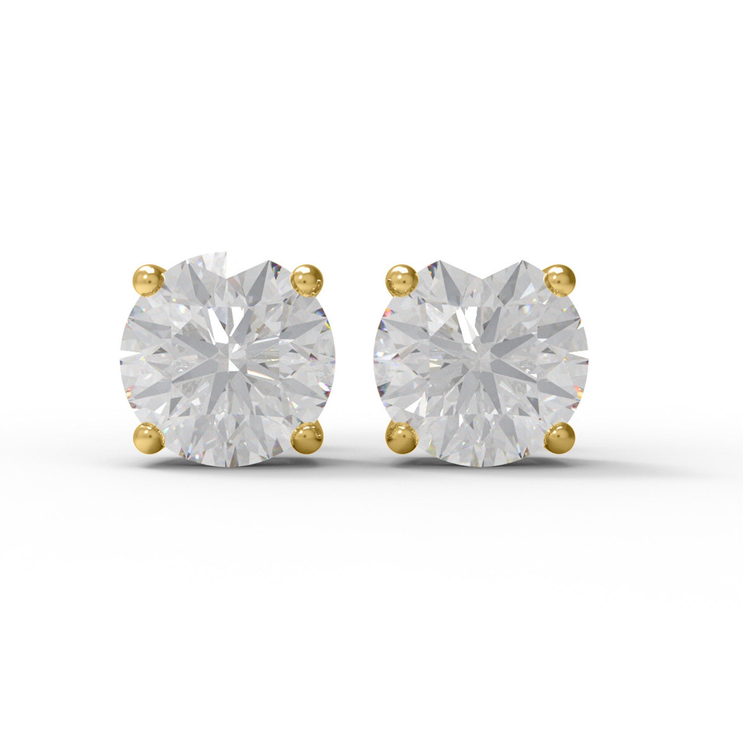 Pair of gold moissanite stud earrings on a white background