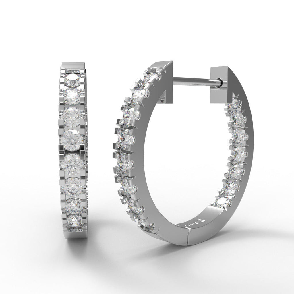 Sterling silver in and out moissanite hoop earrings on a white background