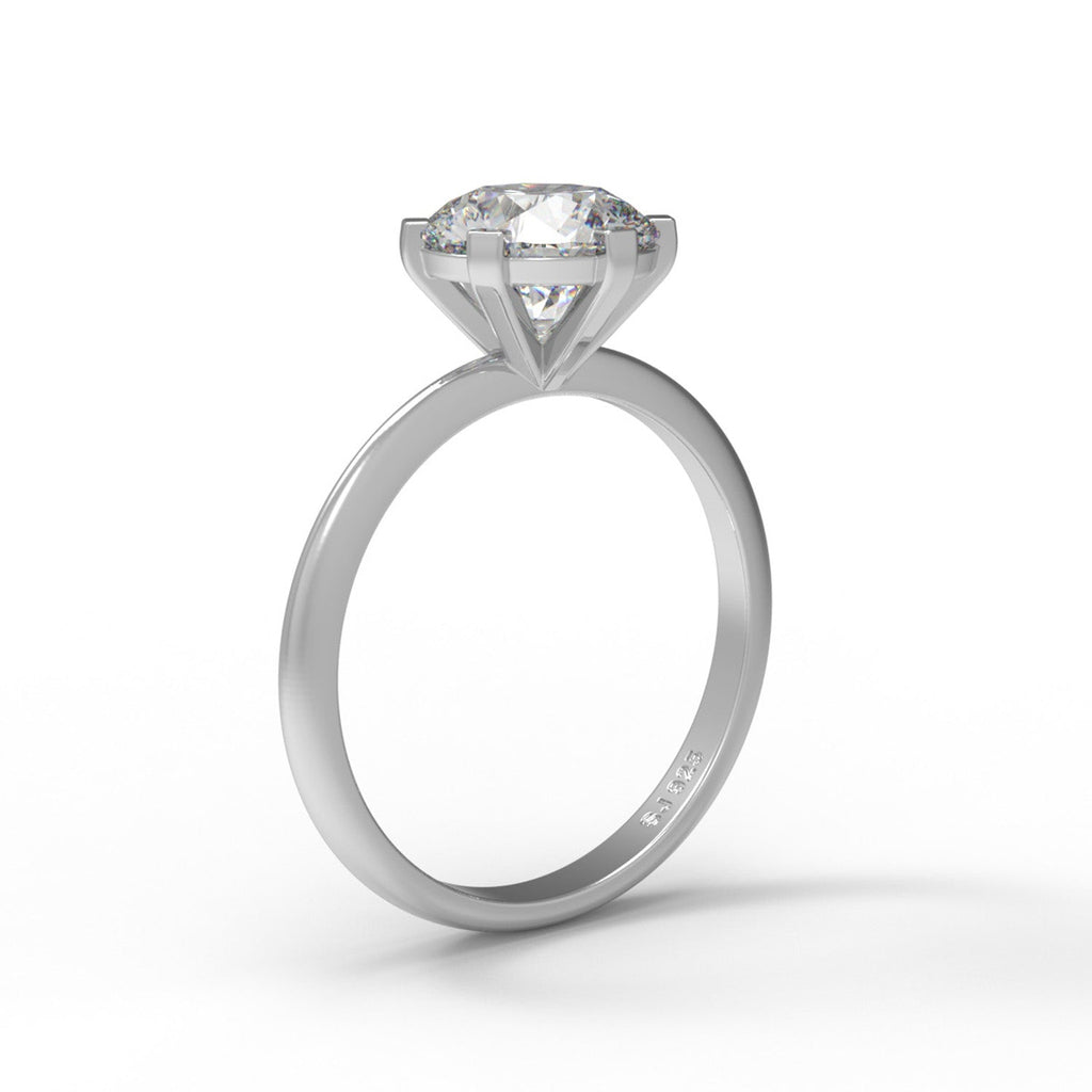 Round-cut sterling silver moissanite solitaire ring on a white background